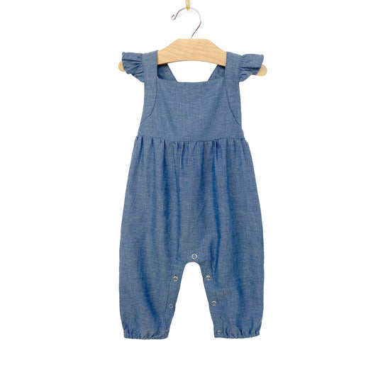 Made with 100% light chambray cotton. Featuring interlock straps, flutter straps, coconut back buttons, and leg snaps for easy changing.
