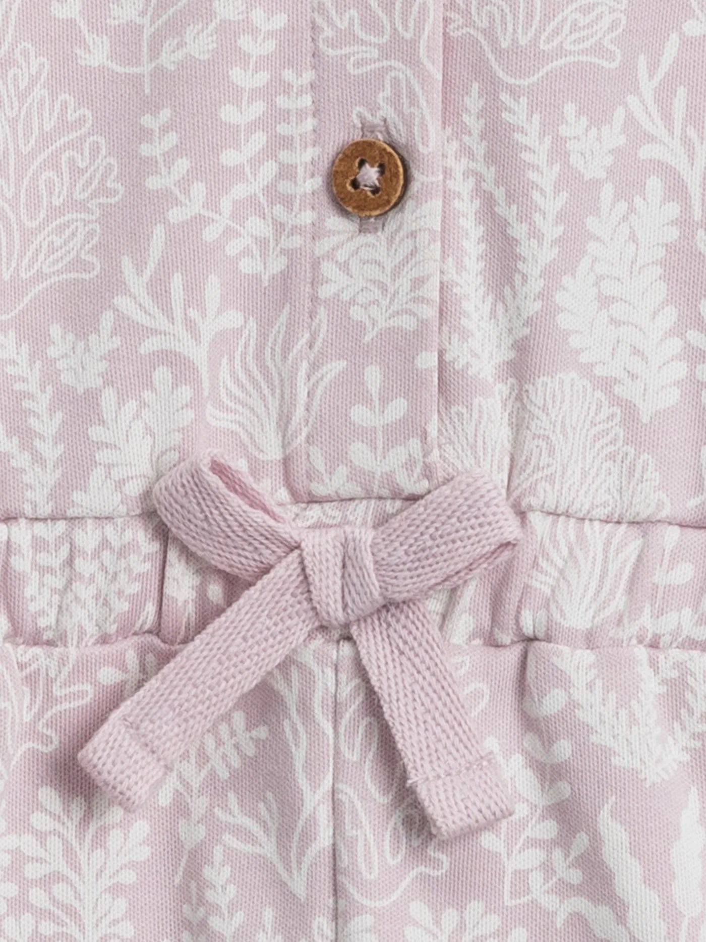 With flutter sleeves, eco-friendly coconut buttons, and an adorable cinched waist, the Shaye Romper is perfect for every outdoor adventure. Made with 100% organic co