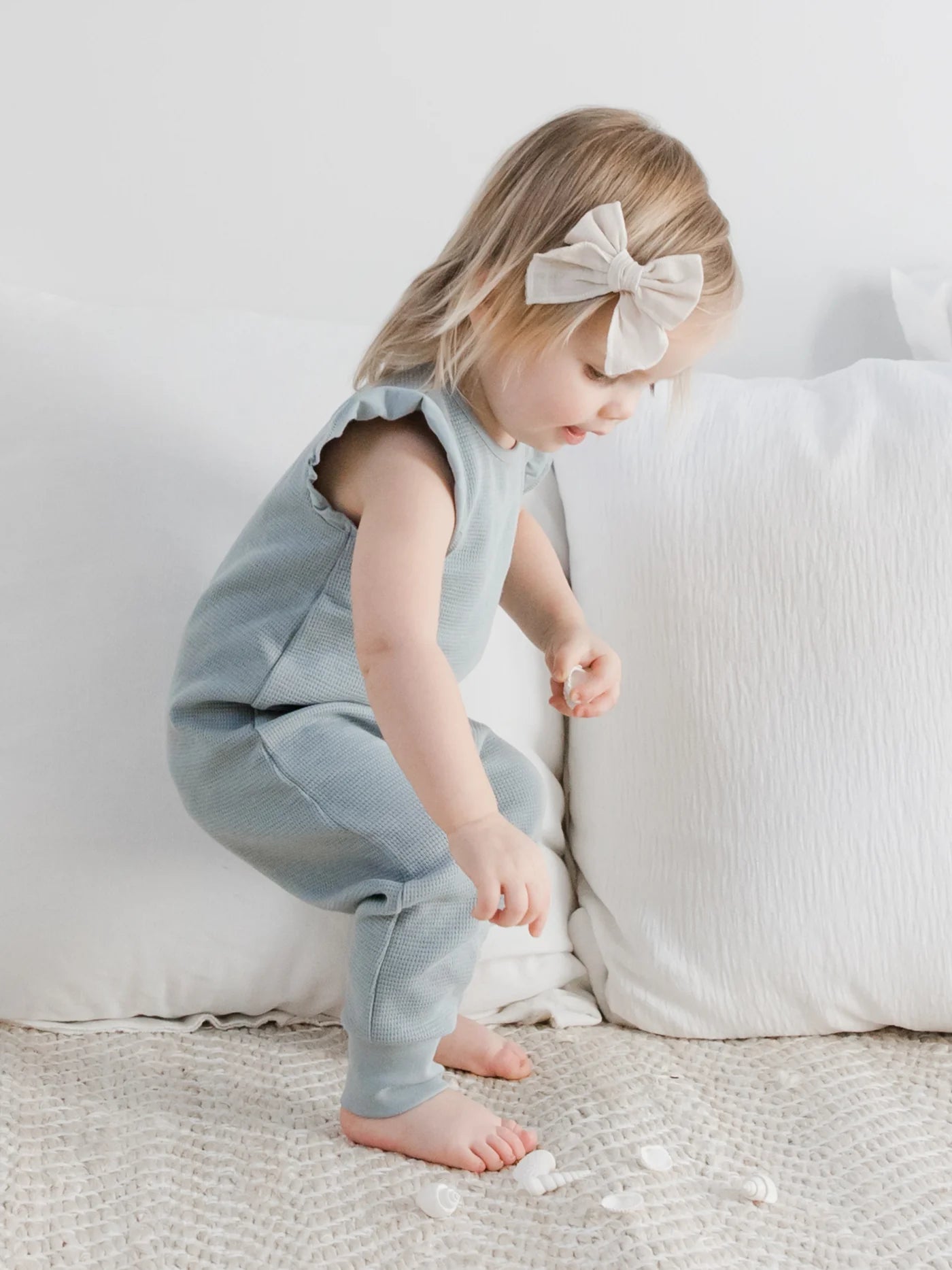 Our Maci Flutter Tank Romper is made from 100% organic waffled cotton, with eco-friendly coconut buttons and nickel-free snaps. The adorable flutter sleeve and neckl
