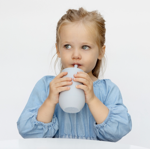 Learning to drink from a straw is an important developmental milestone that develops lip rounding and promotes speech development. The ezpz Happy Cup + Straw System