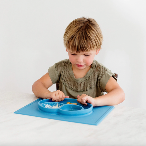 The Happy Mat is ezpz's award-winning flagship product. It is an all-in-one placemat + plate that suctions to the table, which means that it captures the mess and