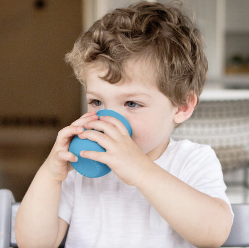 Once children have mastered the skill of drinking from the Tiny Cup, they are ready to drink more ounces of liquid at mealtime with the Mini Cup. That’s right – you