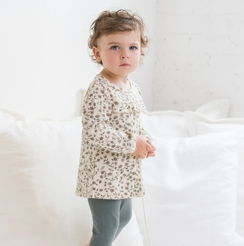 The Sorren is ready for family photos, playground afternoons, and everything in between. With delicate ruffle details, cinched cuffs, and a coconut button closur