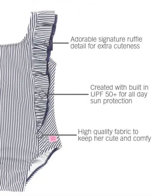 A favorite style in a nautical new navy stripe, it features waterfall detail for added flair. Made from a fabric with UPF 50+ sun protection built in, this girls' r