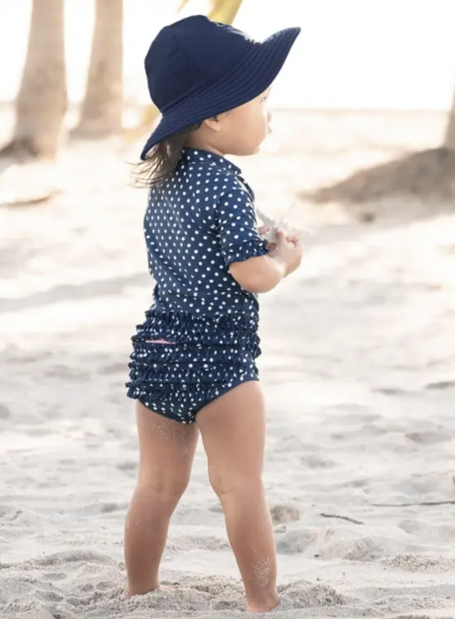 Add style to your little girl’s summer attire with this Navy Polka Dot Ruffled Bikini. This two-piece set is perfect for easy changing and offers sun protection w