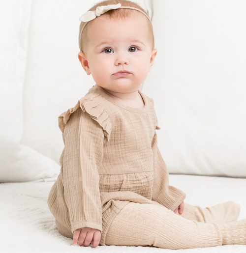 With its relaxed bubble silhouette, adorable flutter puff sleeves, and delicate coconut button closure on the back, the Isla Muslin Bubble Romper makes for the sweet
