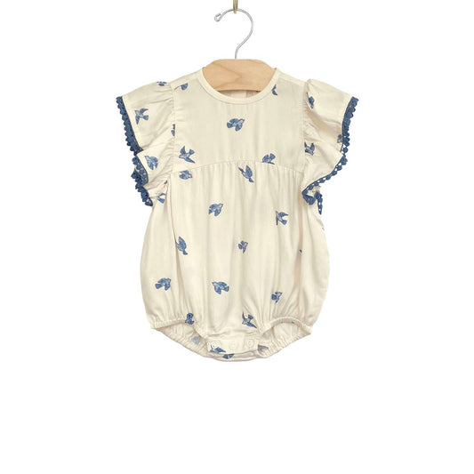 Our embossed romper is made with the softest viscose twill. Soft waistband, embossed details, and the sweetest flutter sleeves in our all over Bluebirds print! Leg s